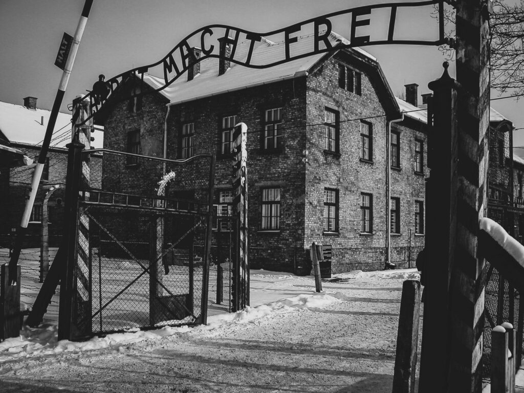 The sign above the gate 'Arbeit macht frei' in translation 'Work sets you free' is one of the symbols of the camp.