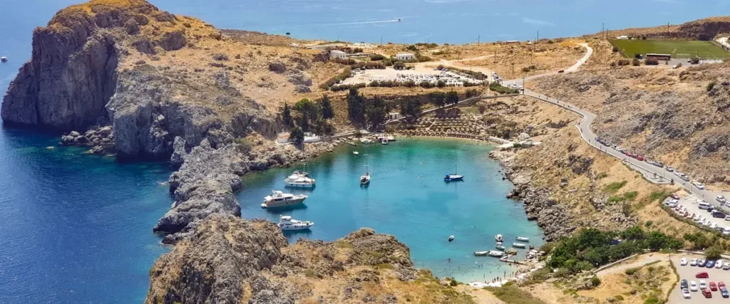 Greek island hopping - aerial view of crystal clear waters and boats in the Cyclades